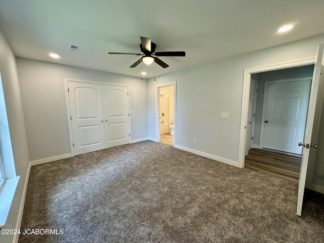 unfurnished bedroom featuring ceiling fan, a closet, and dark colored carpet