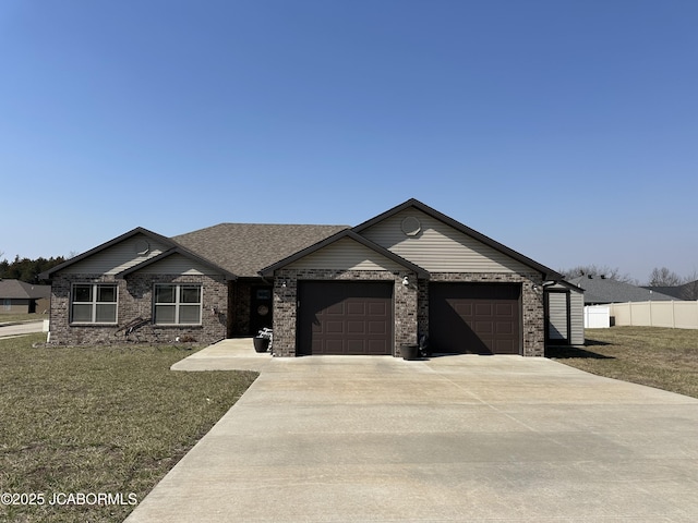 single story home featuring brick siding, fence, a front yard, a garage, and driveway