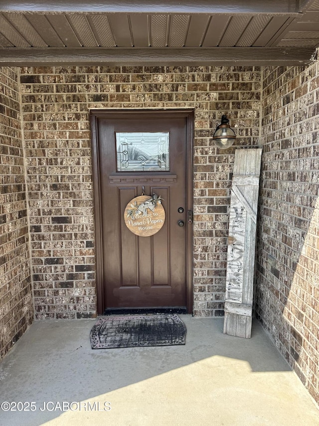 property entrance featuring brick siding