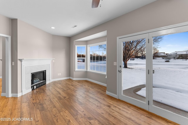 unfurnished living room with a fireplace, a ceiling fan, recessed lighting, hardwood / wood-style floors, and baseboards