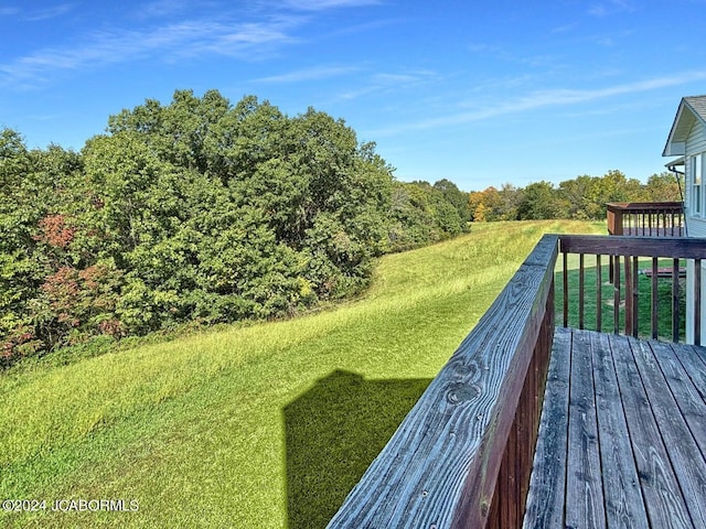 wooden terrace featuring a yard