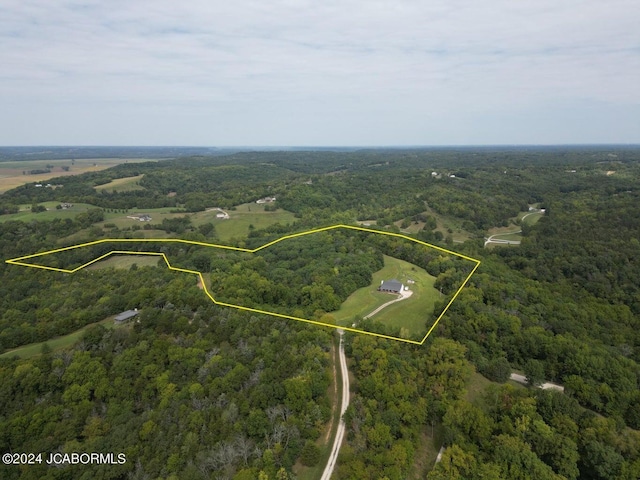 birds eye view of property with a wooded view