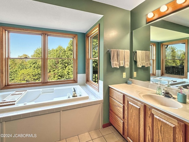 bathroom featuring a tub, vanity, and tile patterned floors