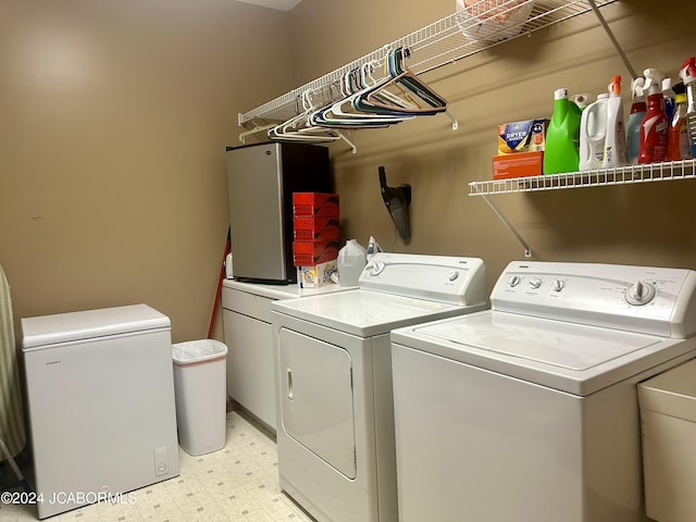 laundry room with laundry area, light floors, and washer and dryer