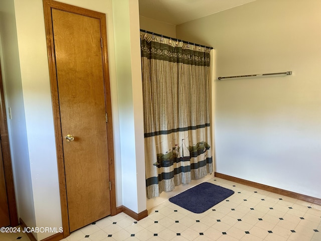 full bathroom with baseboards, curtained shower, and tile patterned floors