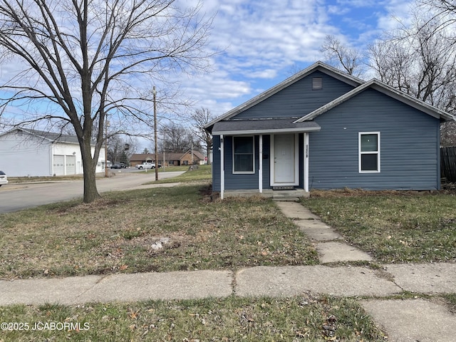 bungalow-style house featuring a front lawn