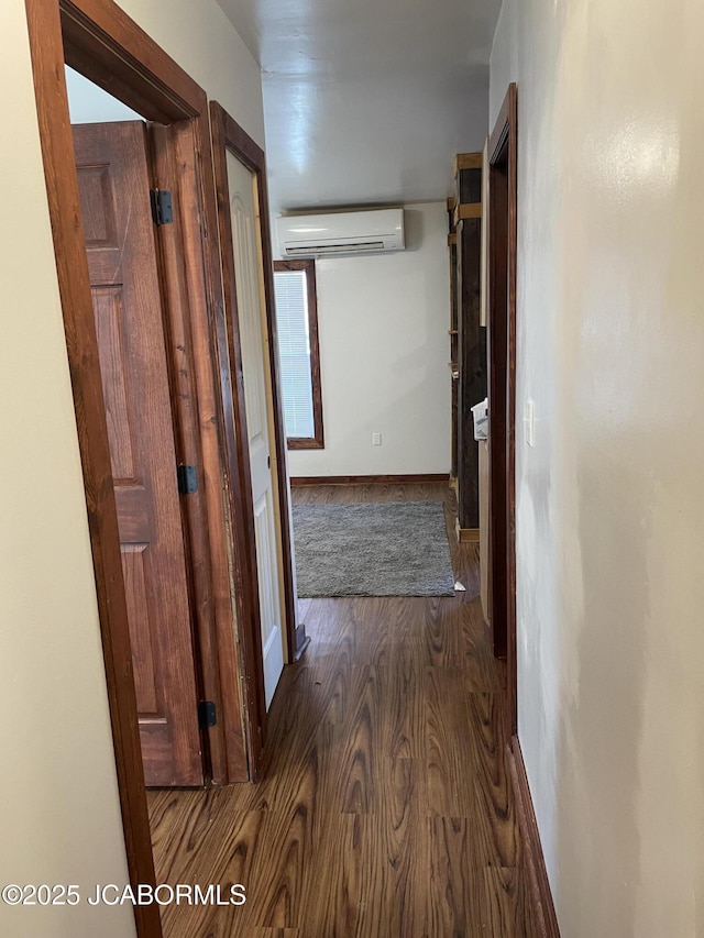 hall featuring an AC wall unit and dark hardwood / wood-style floors