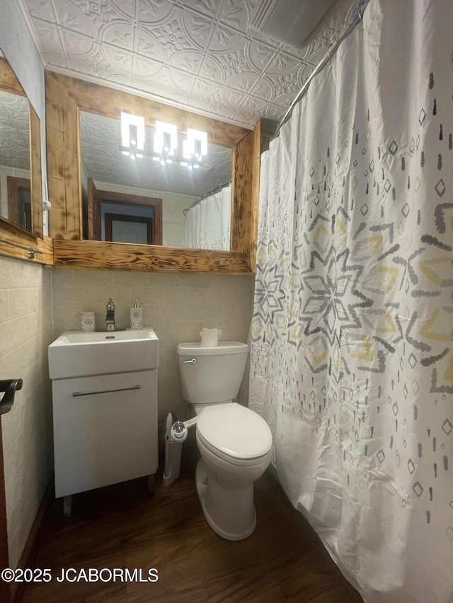 bathroom with wood-type flooring, vanity, toilet, and walk in shower