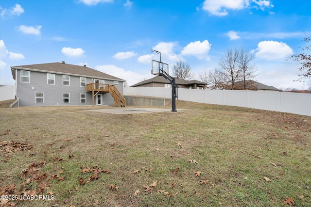 view of yard featuring a wooden deck and a patio