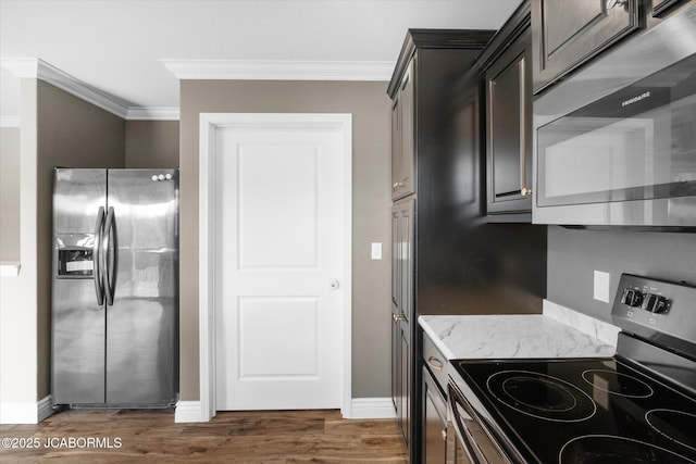 kitchen with dark brown cabinetry, crown molding, dark wood-type flooring, and appliances with stainless steel finishes