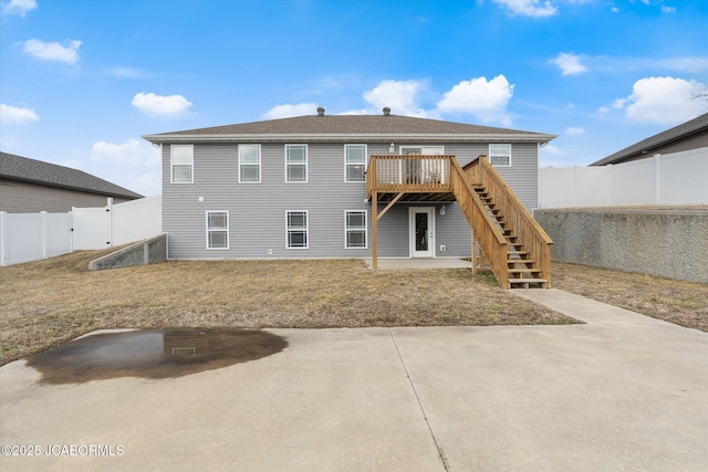 back of house with a wooden deck and a patio area