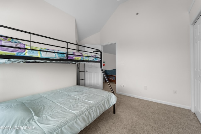 carpeted bedroom with high vaulted ceiling and baseboards