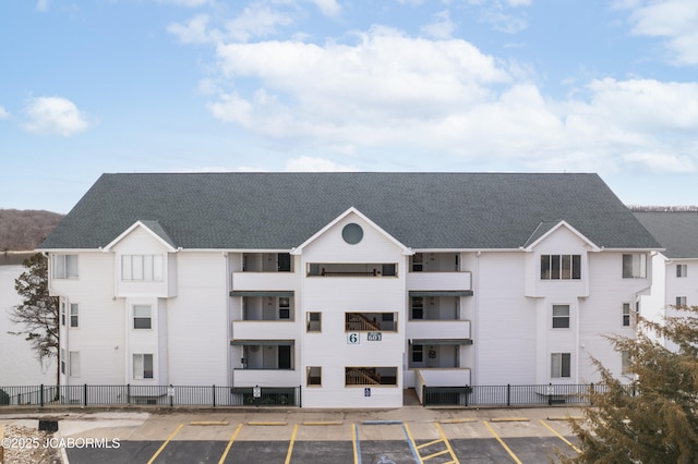 view of building exterior with uncovered parking