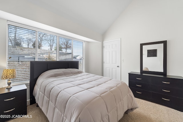 bedroom with lofted ceiling and light carpet