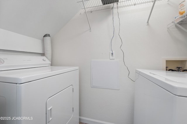 clothes washing area featuring laundry area and washing machine and dryer