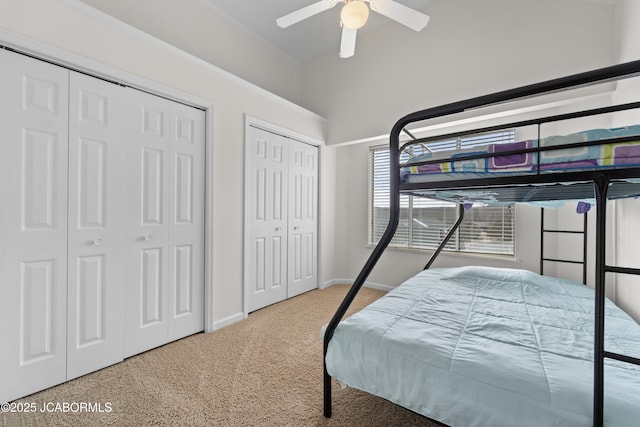 bedroom with multiple closets, carpet flooring, baseboards, and a ceiling fan