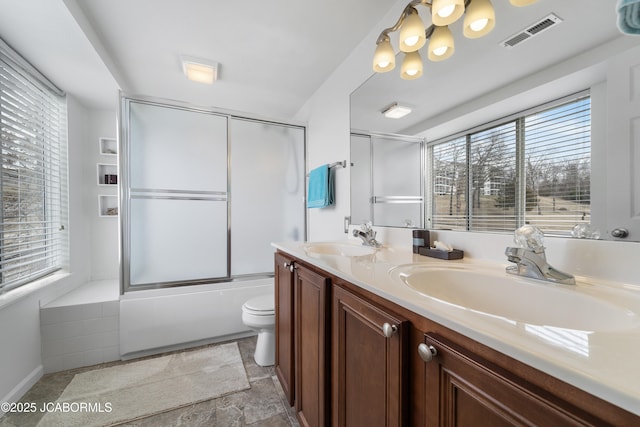 bathroom featuring a healthy amount of sunlight, visible vents, and a sink