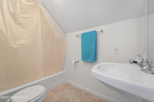 bathroom with lofted ceiling, toilet, a sink, tile patterned floors, and shower / tub combo with curtain