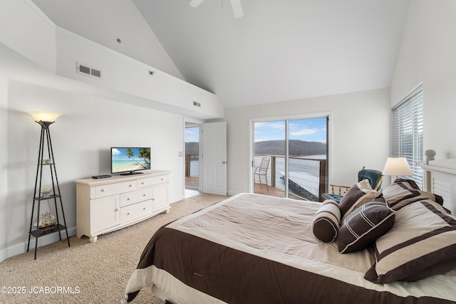 bedroom with light carpet, multiple windows, visible vents, and access to exterior