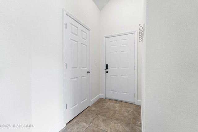 doorway to outside with baseboards