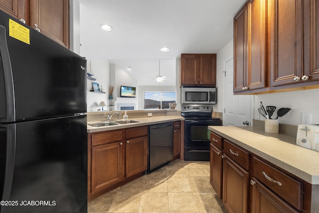 kitchen featuring ceiling fan, a peninsula, a sink, light countertops, and black appliances