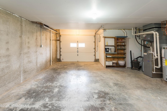 garage featuring electric water heater and heating unit