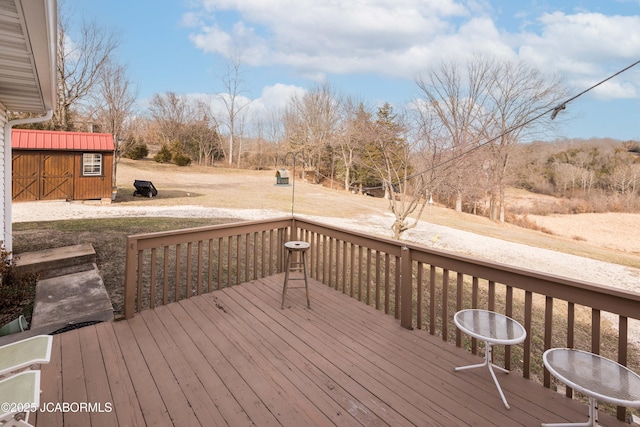 wooden deck with an outbuilding and a storage shed