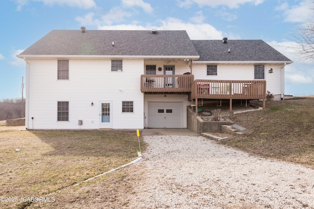 back of property with a yard, driveway, a shingled roof, and an attached garage