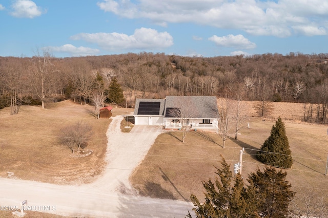 birds eye view of property with a view of trees and a rural view