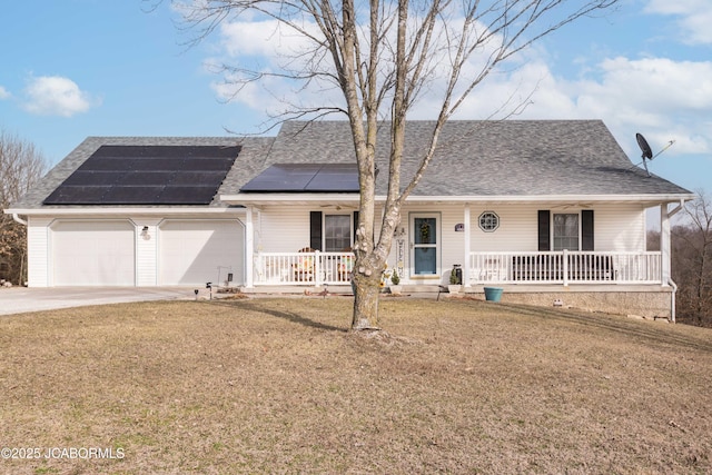 single story home with driveway, solar panels, a porch, an attached garage, and a front lawn