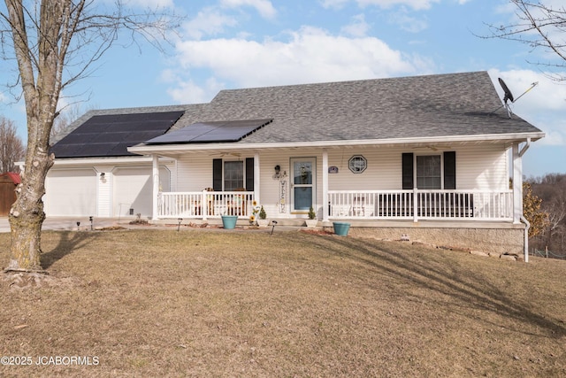 ranch-style home featuring a garage, roof with shingles, roof mounted solar panels, a porch, and a front yard