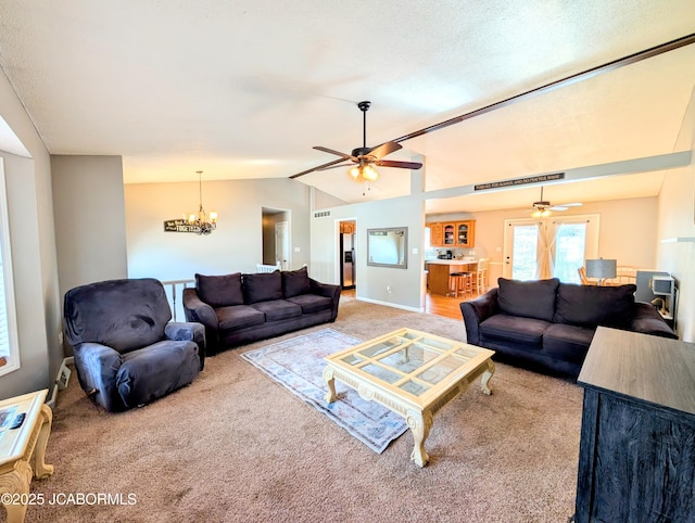 living room featuring light carpet, ceiling fan with notable chandelier, vaulted ceiling, and a textured ceiling