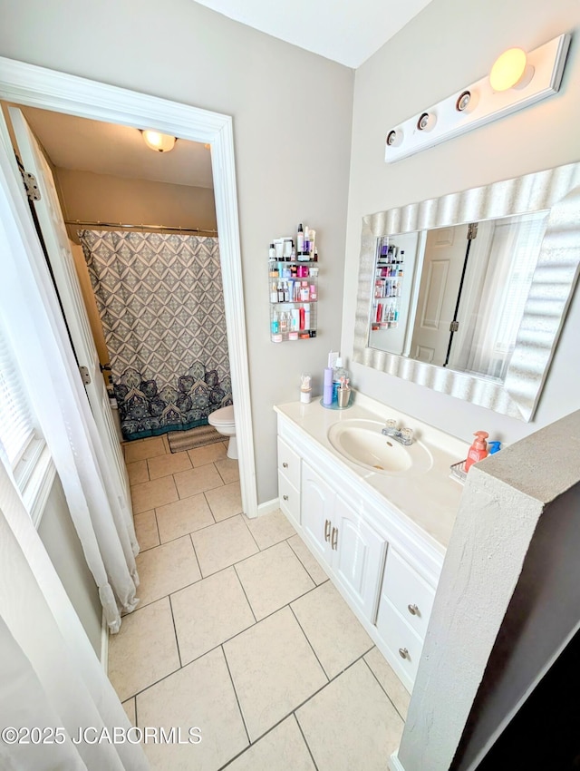 bathroom featuring tile patterned flooring, vanity, and toilet