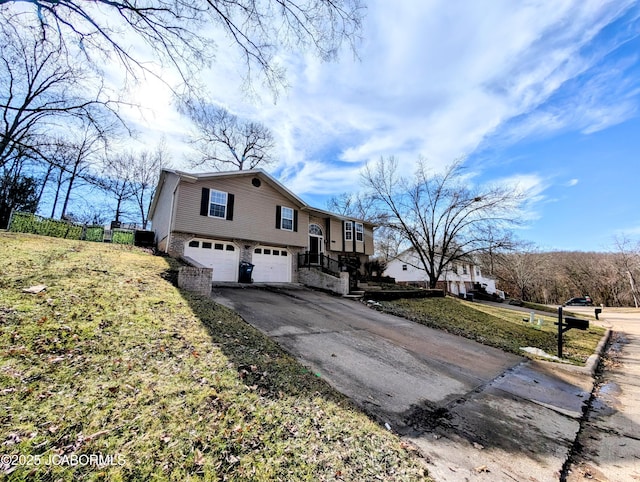 view of front of property featuring a garage and a front lawn