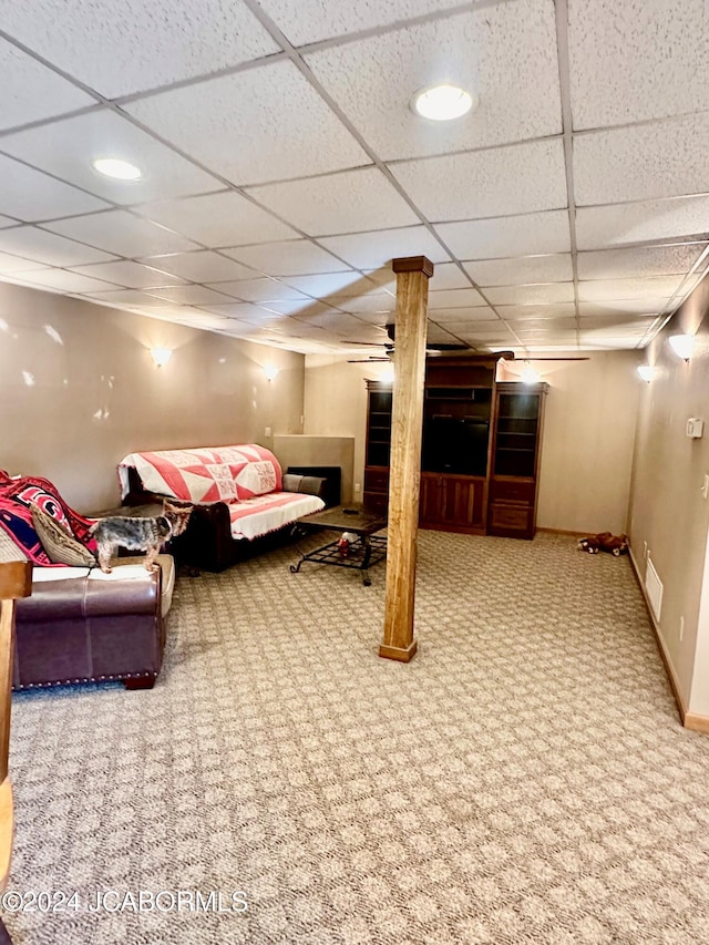 basement with carpet and a paneled ceiling