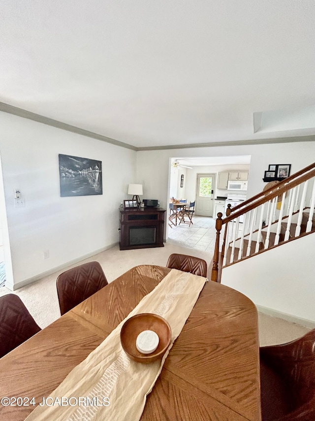 dining area featuring crown molding and carpet floors