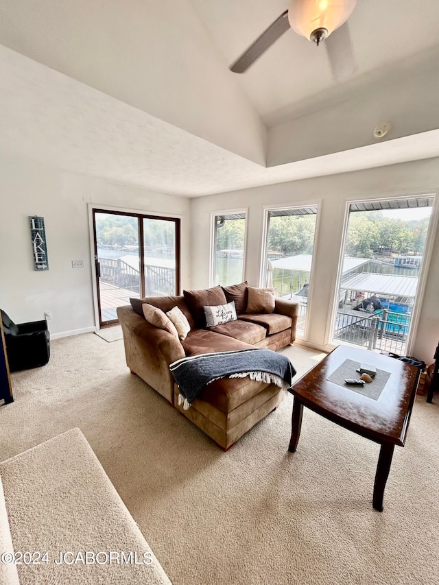 living room with vaulted ceiling, light carpet, and ceiling fan