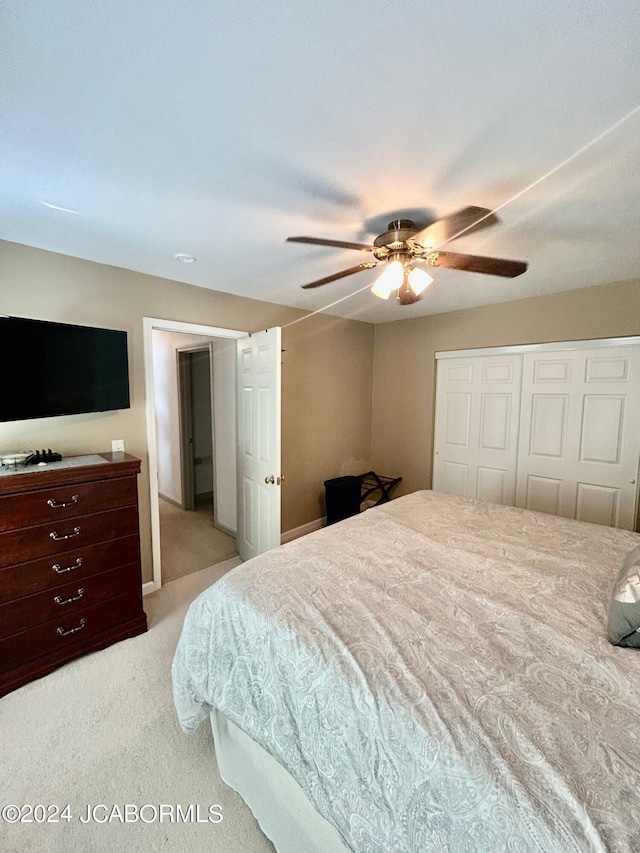 bedroom with light carpet, a closet, and ceiling fan