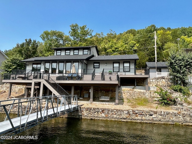 back of house with a deck with water view