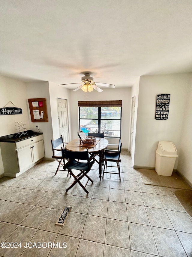 tiled dining room with ceiling fan