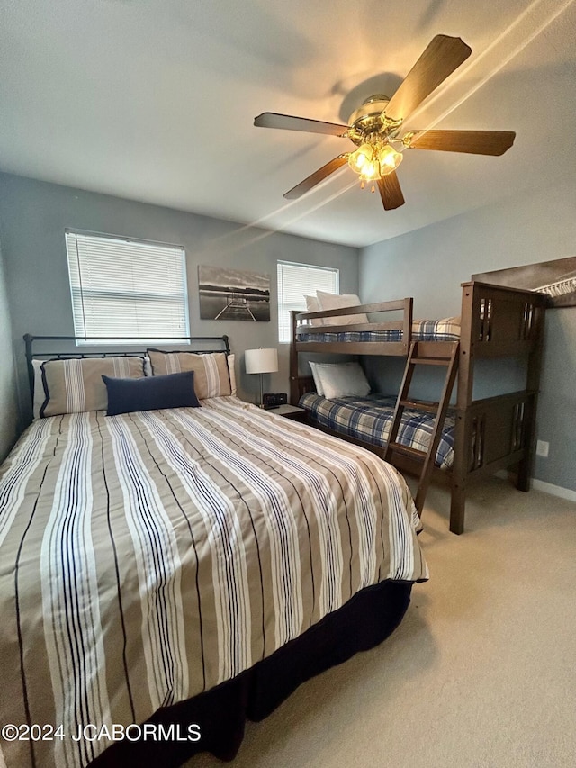 bedroom featuring ceiling fan and light carpet