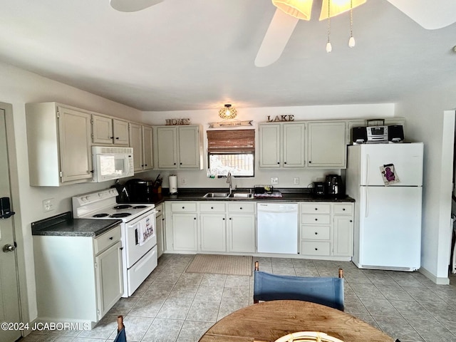 kitchen featuring sink, light tile patterned floors, white cabinets, and white appliances