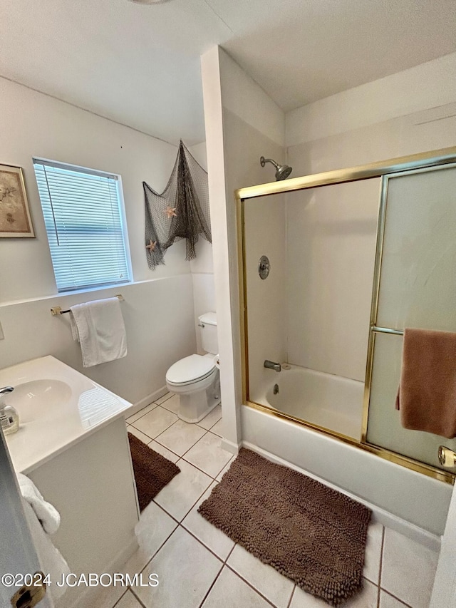 full bathroom with enclosed tub / shower combo, vanity, tile patterned floors, and toilet