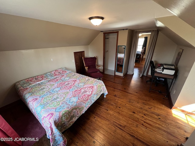bedroom with hardwood / wood-style floors and vaulted ceiling