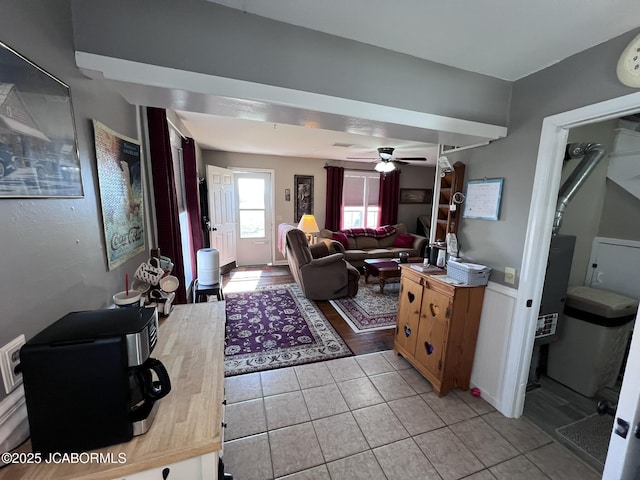 living room featuring light tile patterned floors and ceiling fan