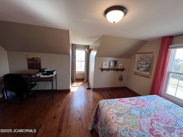 bedroom with wood-type flooring, lofted ceiling, baseboards, and an office area