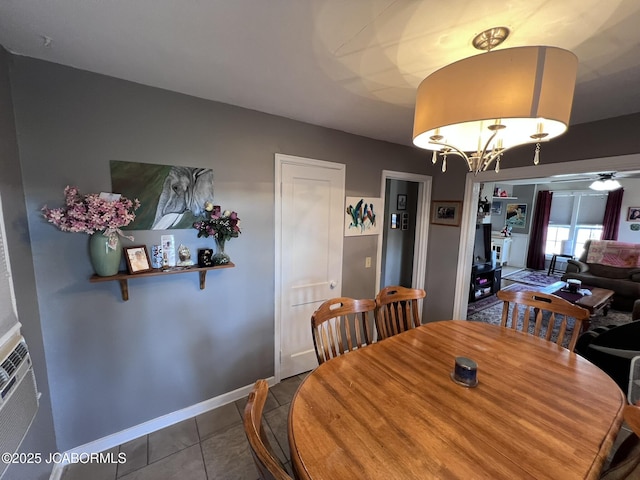 dining area with tile patterned floors, baseboards, and a chandelier