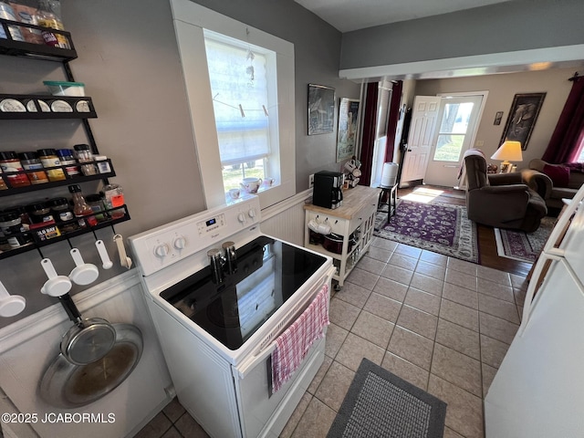 laundry room featuring tile patterned floors and wainscoting