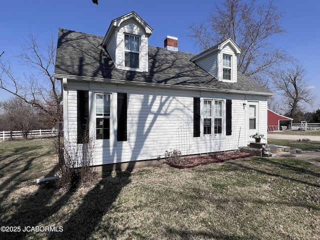 view of property exterior with a chimney and a shingled roof