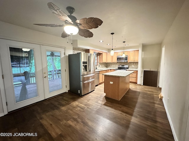 2412 Scenic Dr, Jefferson City, MO 65101 - kitchen featuring stainless steel appliances, backsplash, dark wood-style floors, a kitchen island, and light brown cabinetry